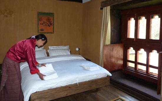 A woman cleaning the king room in the Lechuna Lodge in Haa, Bhutan
