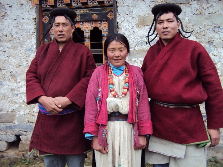 Eastern Bhutanese Brokpa people standing out the front of a building