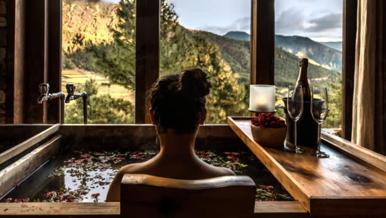 Lady soaking in a hot stone bath Gangtey Lodge Phobjikha Valley Bhutan