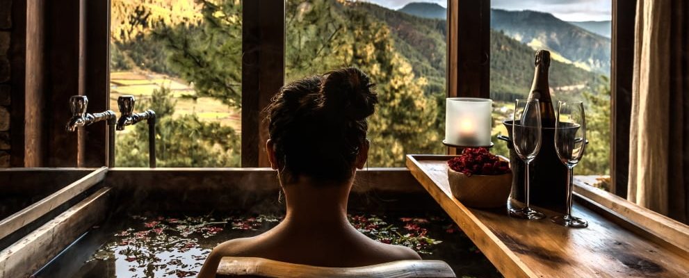 Lady enjoying a traditional Bhutanese remedial Hot Stone Bath at the fabulous, award winning, Gangtey Lodge in the remote Phobjikha valley. Some of Bhutan's best hiking here too.